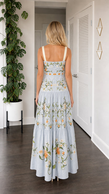 Back view of model wearing light blue embroidered tiered maxi dress