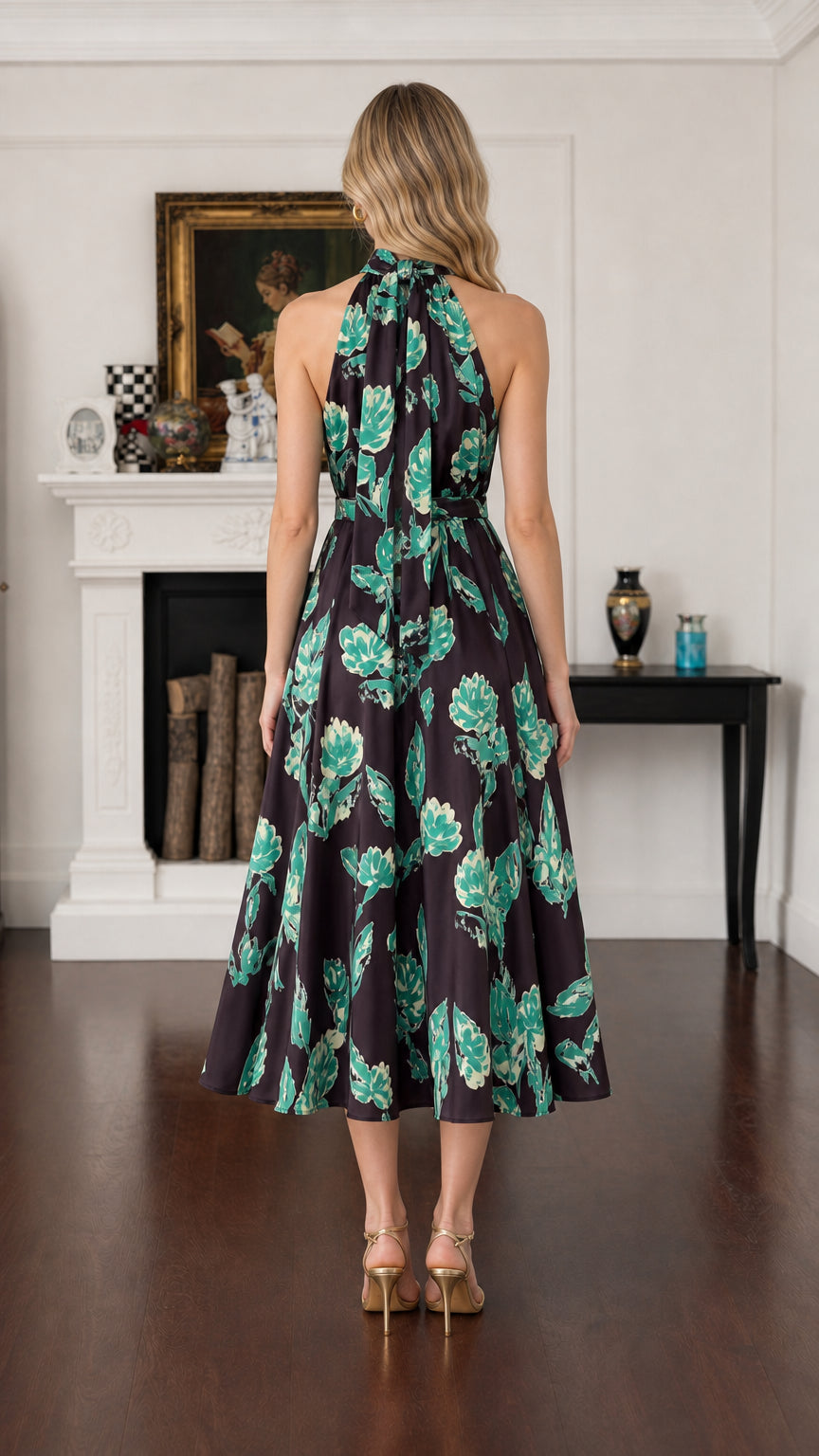 Back view of model showing halter cut and flowy midi skirt in Black Floral
