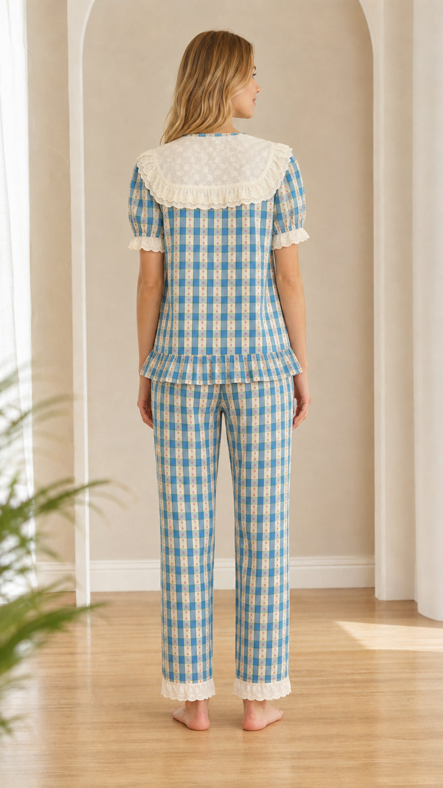 Back view of model wearing blue gingham pajama set showing wide eyelet lace collar