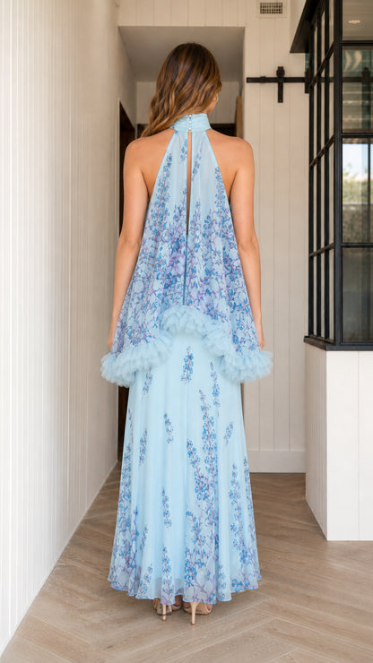 Back view of model in light blue floral halter maxi dress