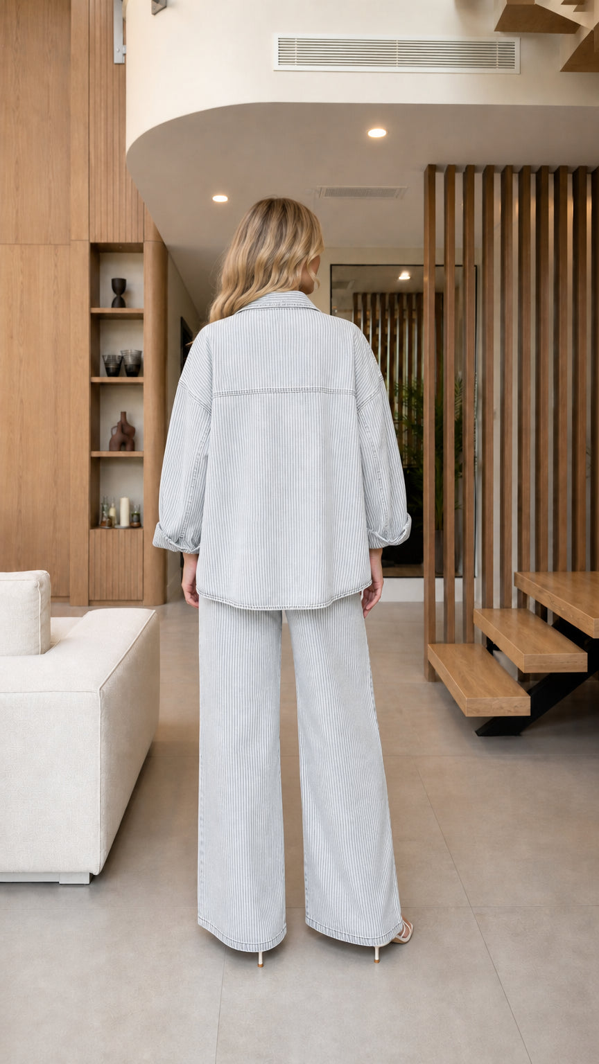 Back view of model wearing Light Blue striped denim shacket and matching wide-leg trousers
