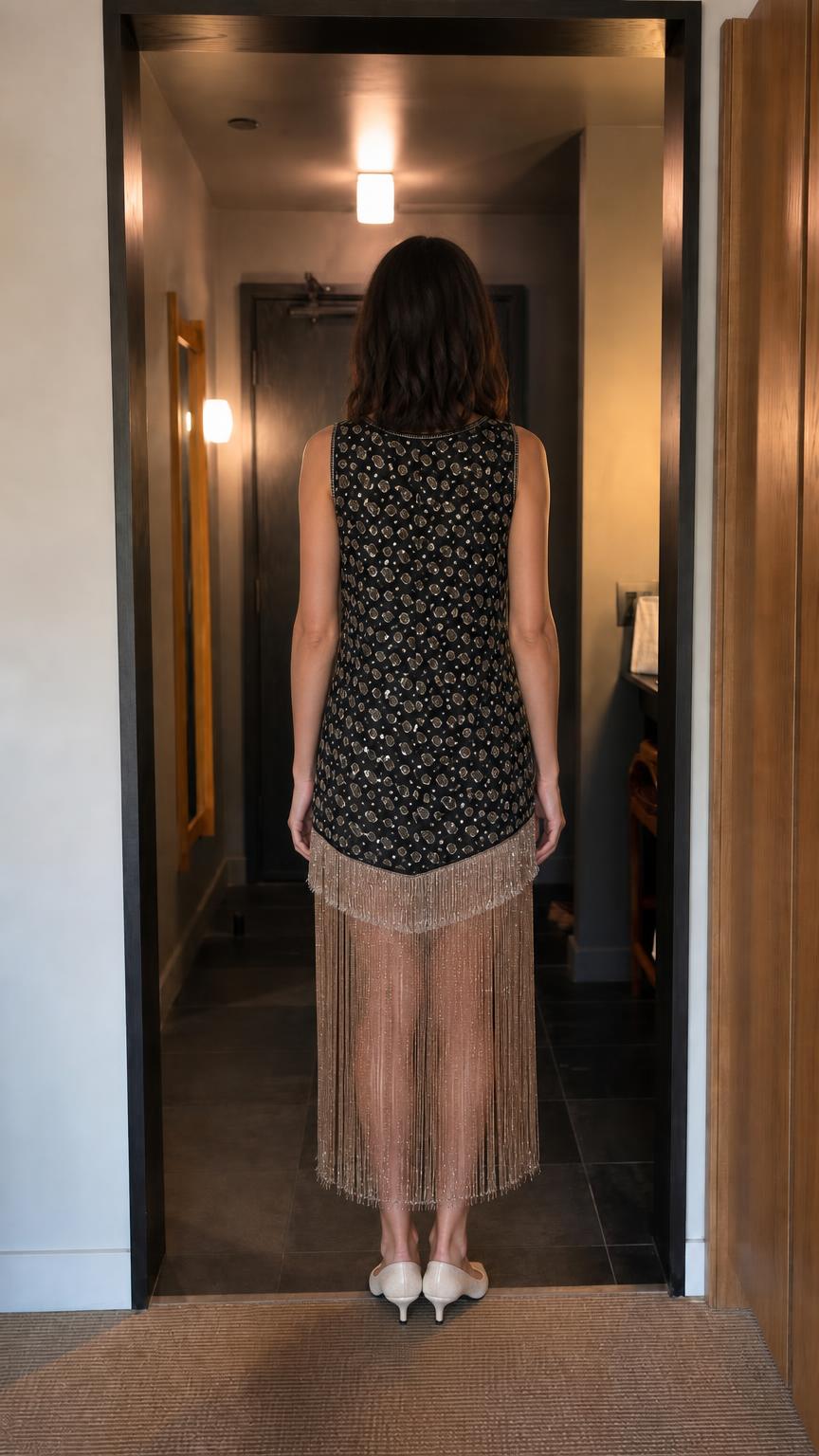 Back view of woman in black beaded fringe midi dress