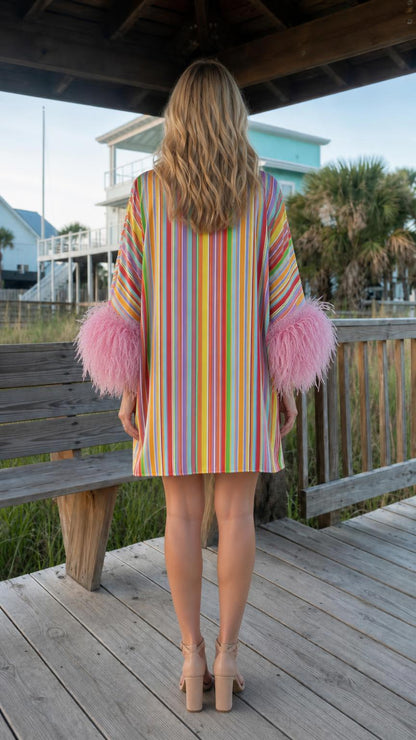 Back view of vibrant multi-color striped feather-trim dress