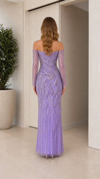 Back view of model in lavender off-the-shoulder embellished long sleeve gown