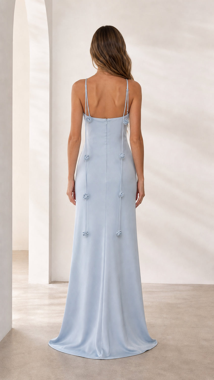 Back view of light blue formal gown with trailing floral details