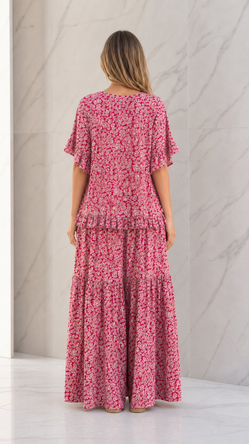 Back full view of woman wearing Rose Pink floral ruffle sleeve top and wide-leg pants