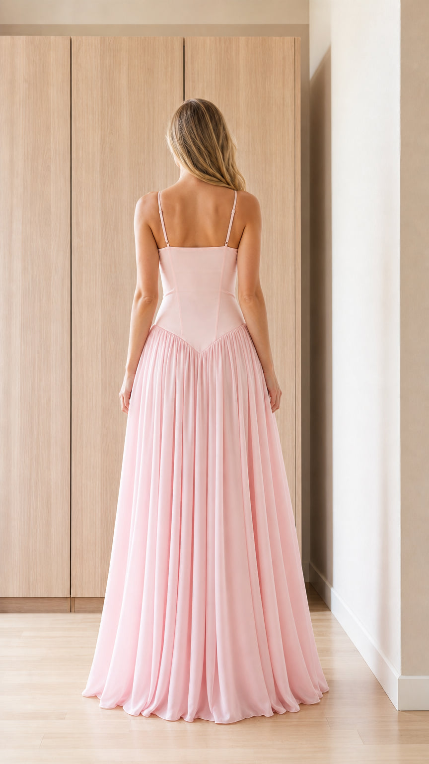 Back view of model in pink bustier evening gown