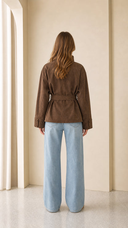 Woman wearing brown faux suede jacket back view