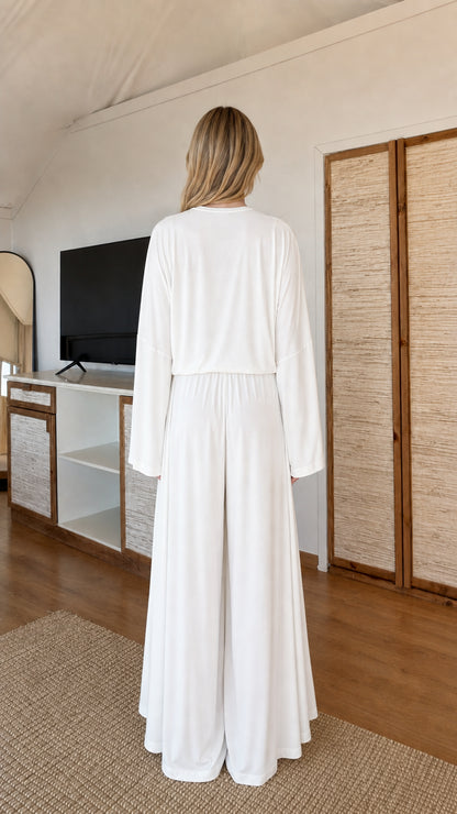 Back view of model wearing White 3-piece loungewear set showing fluid drape