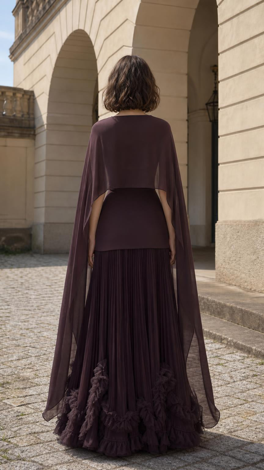 Back view of woman wearing plum cape maxi dress