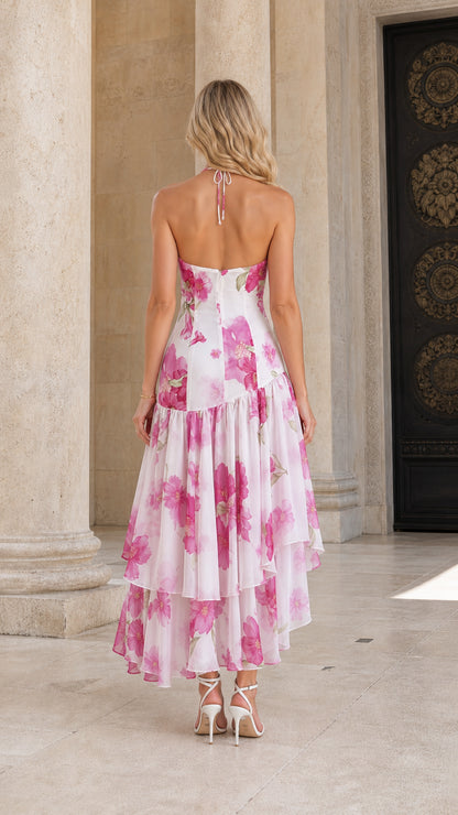 Model wearing white floral halter high-low maxi dress from back view