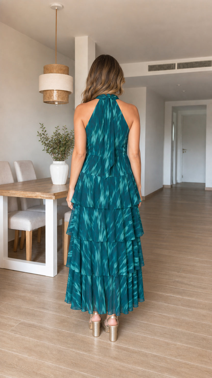Woman wearing teal tiered halter maxi dress from the back