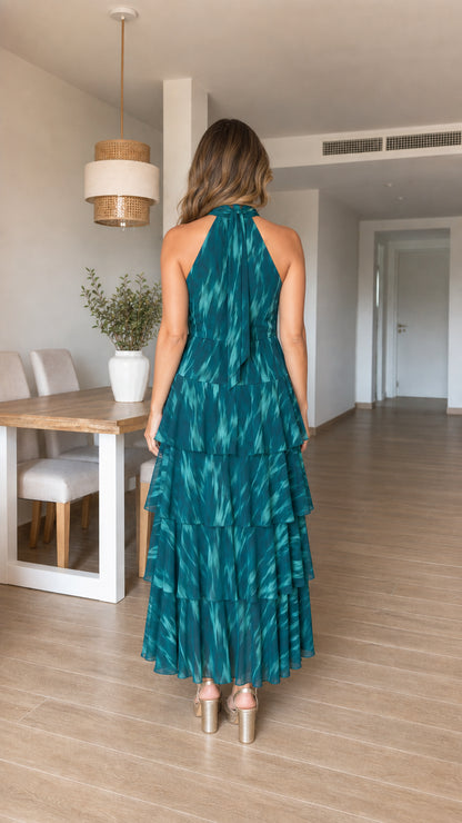Woman wearing teal tiered halter maxi dress from the back