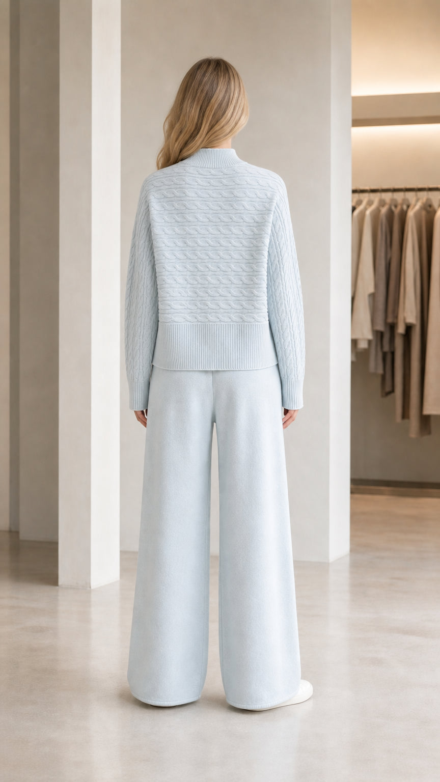 Back view of model wearing light blue ribbed mock neck knit pullover