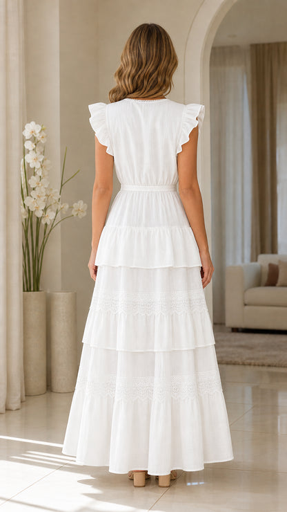 Back view of woman wearing white ruffle sleeve tiered maxi dress