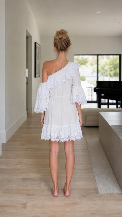 Back view of model in white one-shoulder ruffle lace mini dress