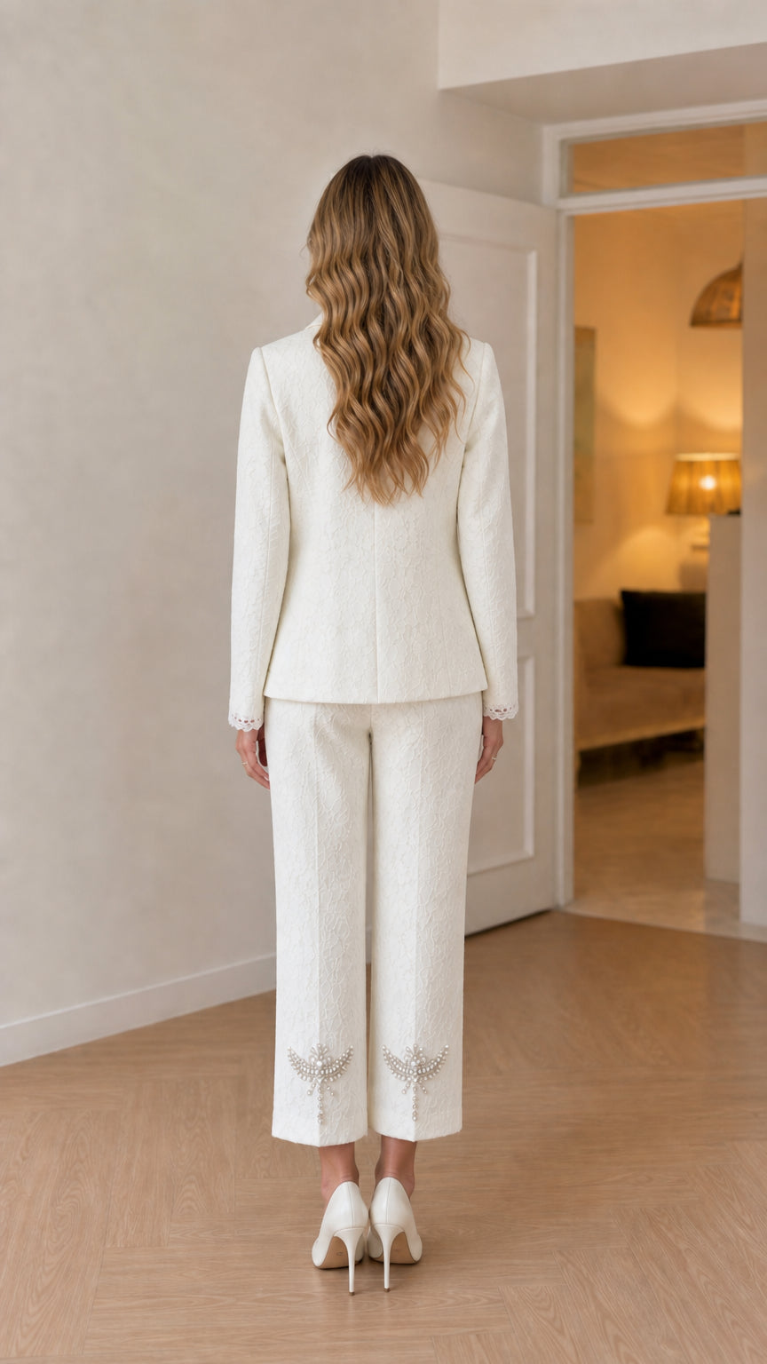Back view of model wearing white structured 2-piece pantsuit