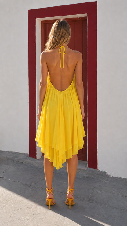 Back view showcasing halter neck tie and open back of yellow dress