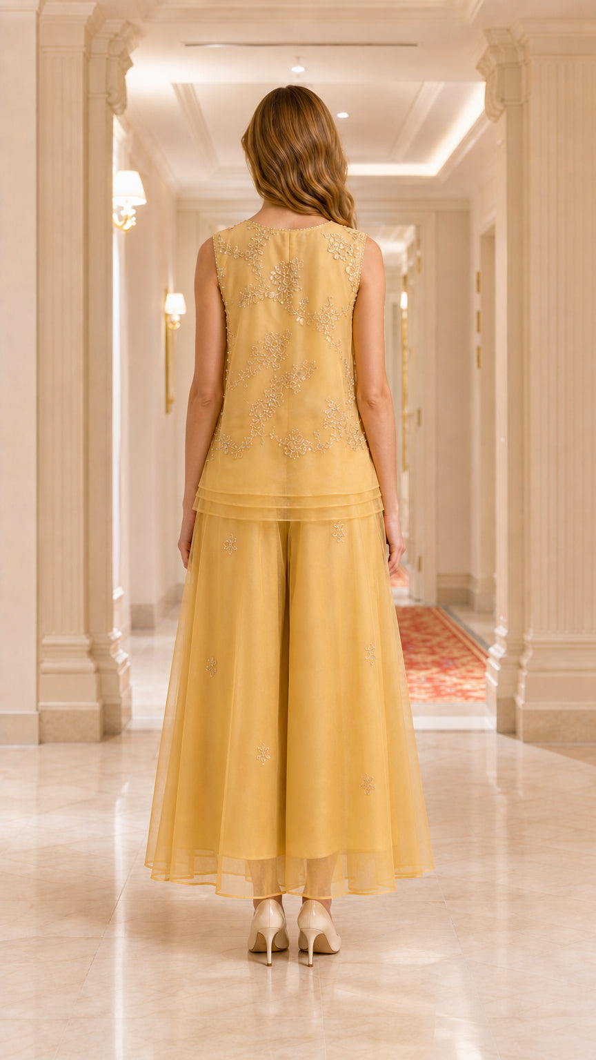 Back view of model in gold sleeveless embroidered evening pant set