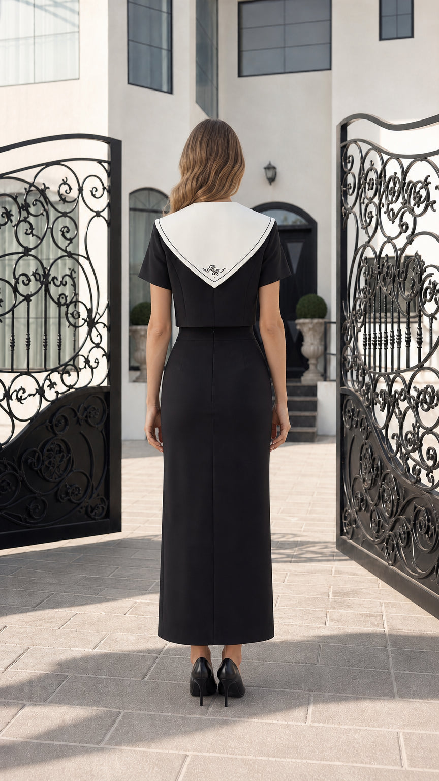 Back view of model in black cropped blazer suit set showing contrast sailor collar back