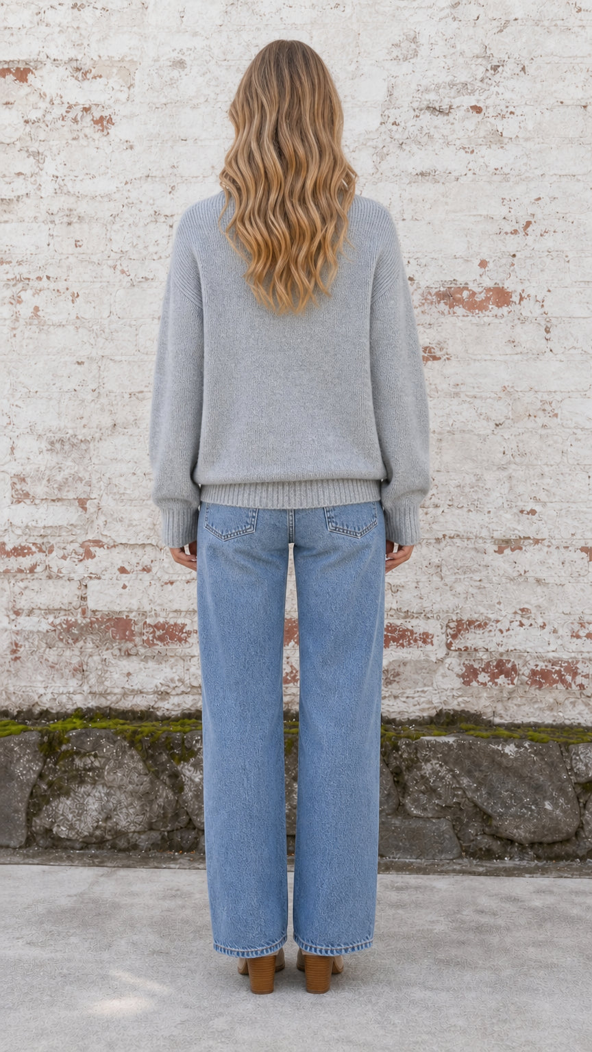 Back view of model wearing heather grey relaxed knit pullover