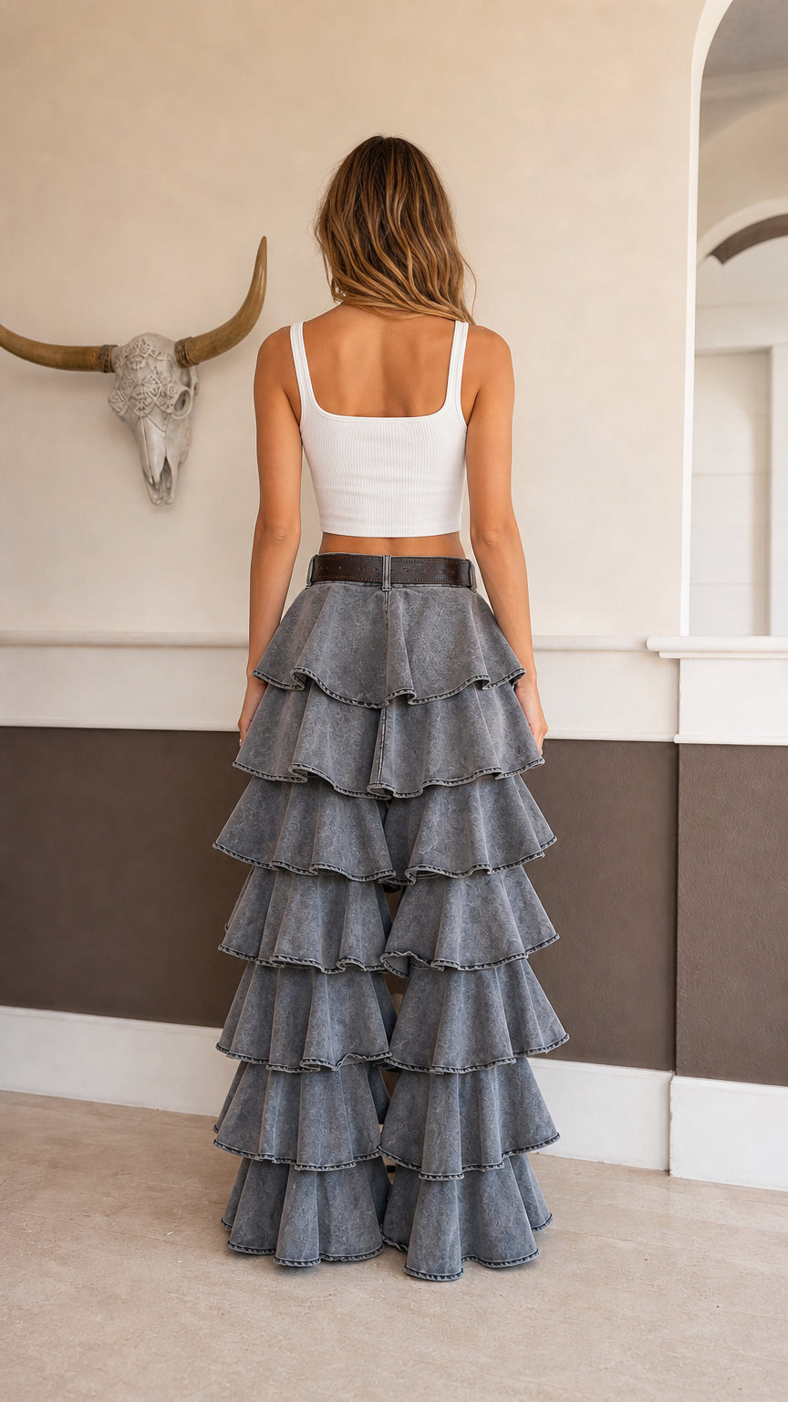 Back view of model wearing high rise washed grey ruffle flare pants