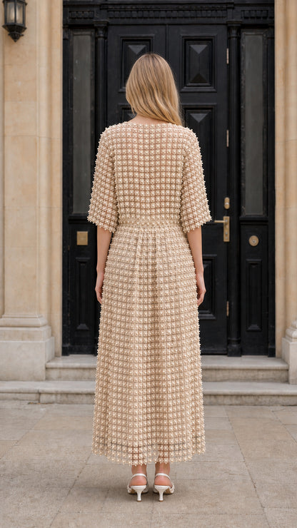 Back view of model wearing beige textured midi dress