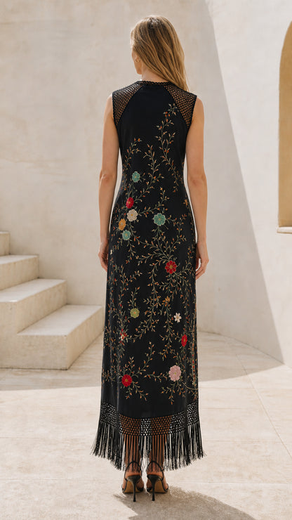 Back view of model wearing black embroidered fringe maxi dress