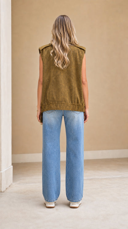 Back view of model showing relaxed fit and elastic hem of olive green suede vest