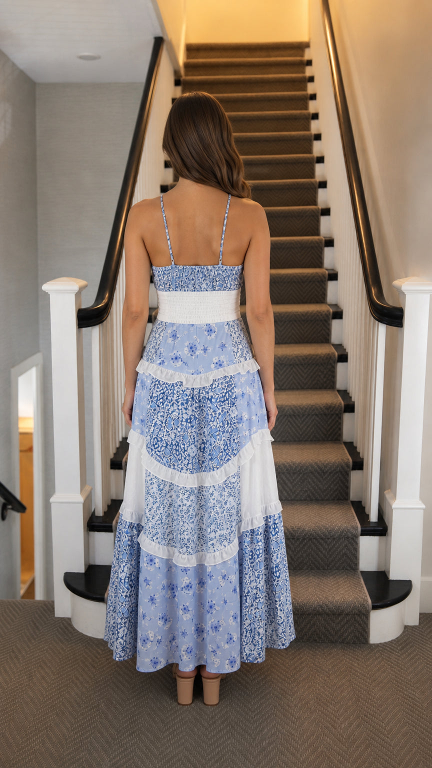 Back view of woman wearing blue floral tiered maxi dress