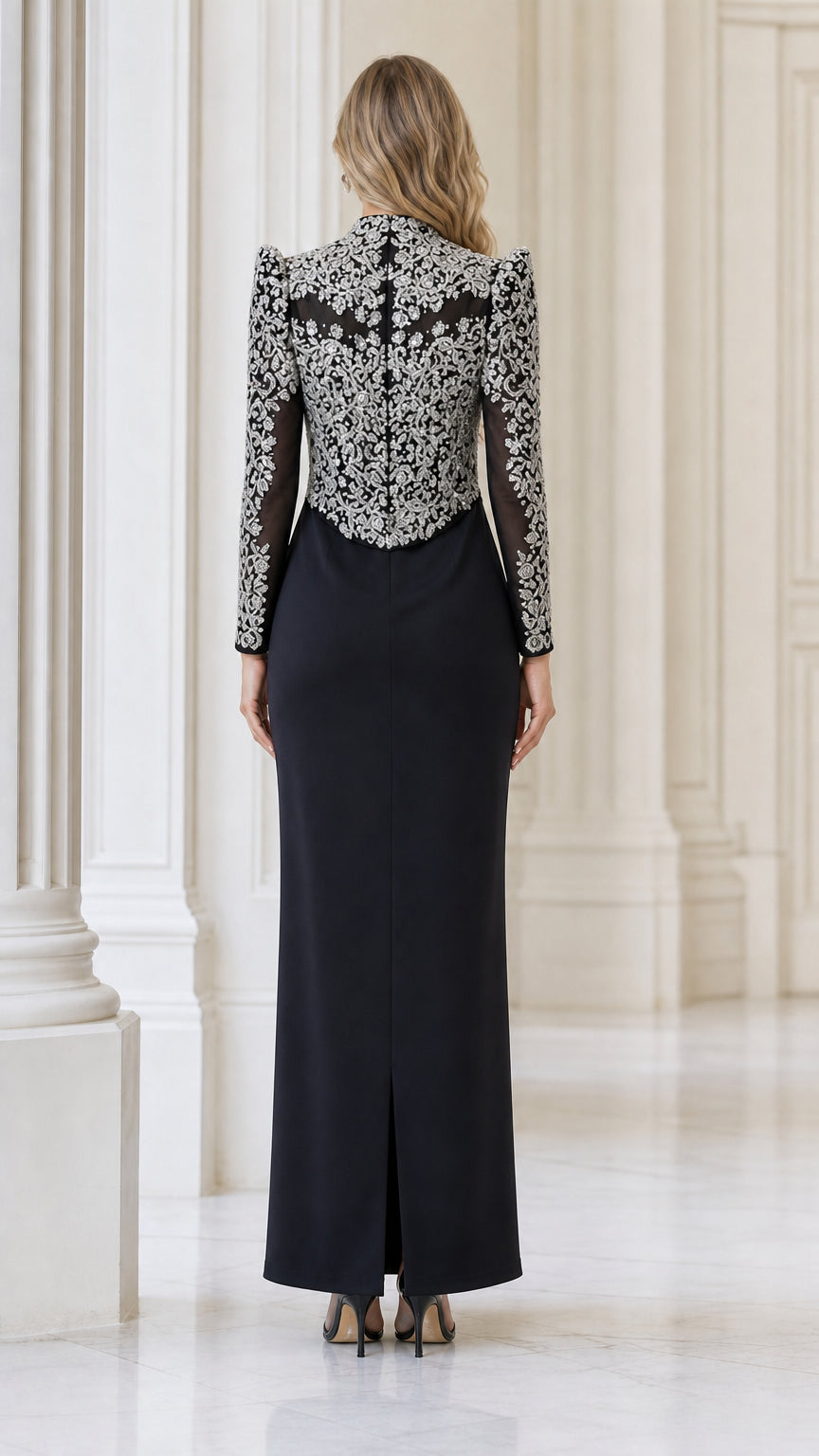 Back view of black maxi evening gown highlighting back slit and jacket detail