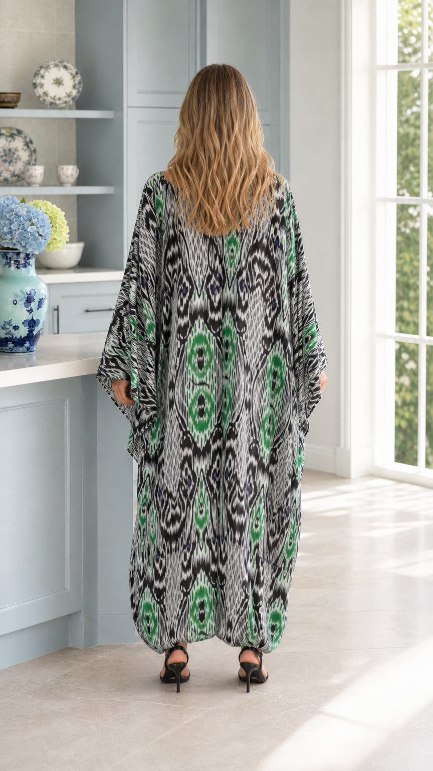 Back view of woman wearing emerald green Ikat print maxi kaftan dress