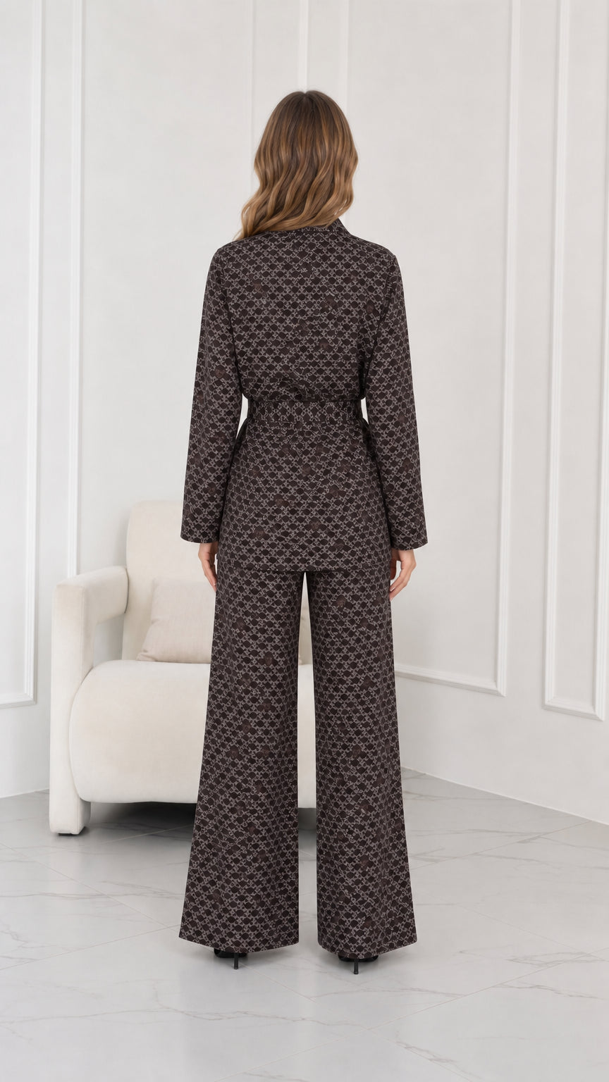 Back view of model wearing brown tailored print jacket and wide leg trousers