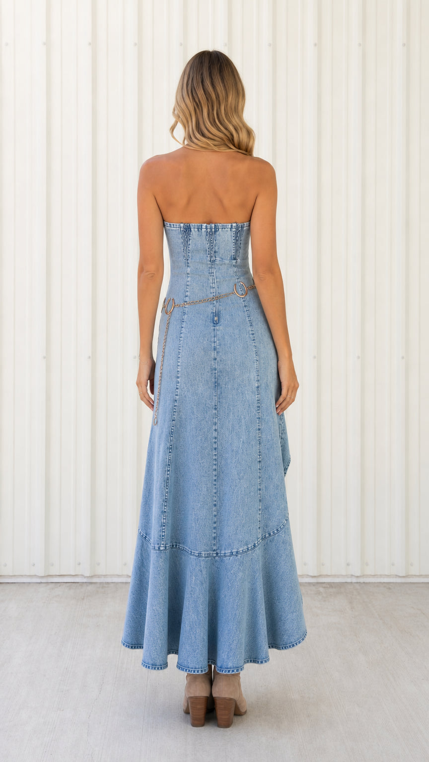 Back view of light blue strapless denim dress showing back seam details