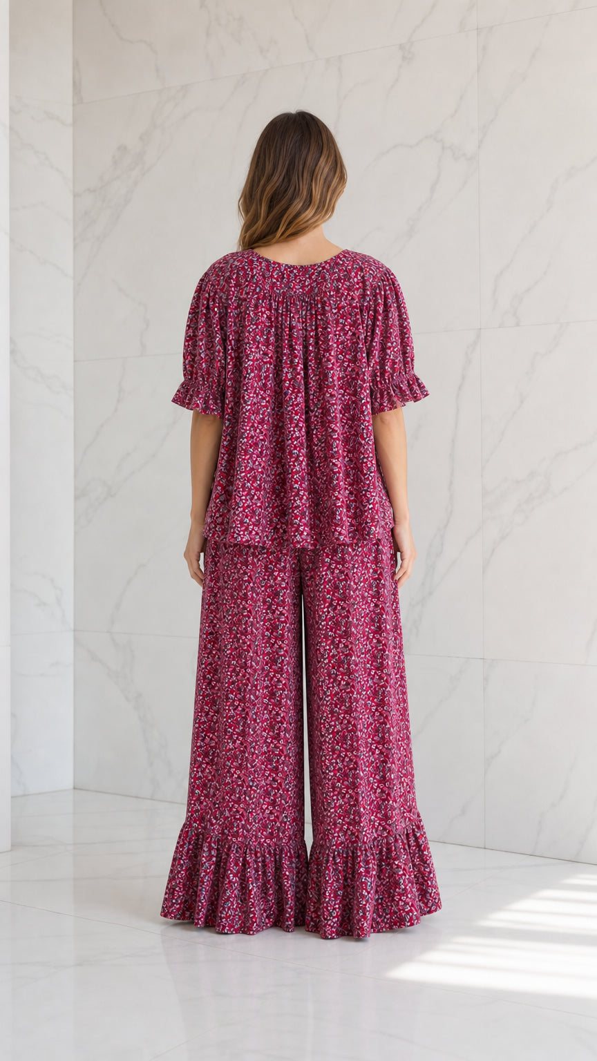 Back view of model wearing magenta floral short sleeve top and wide-leg pants