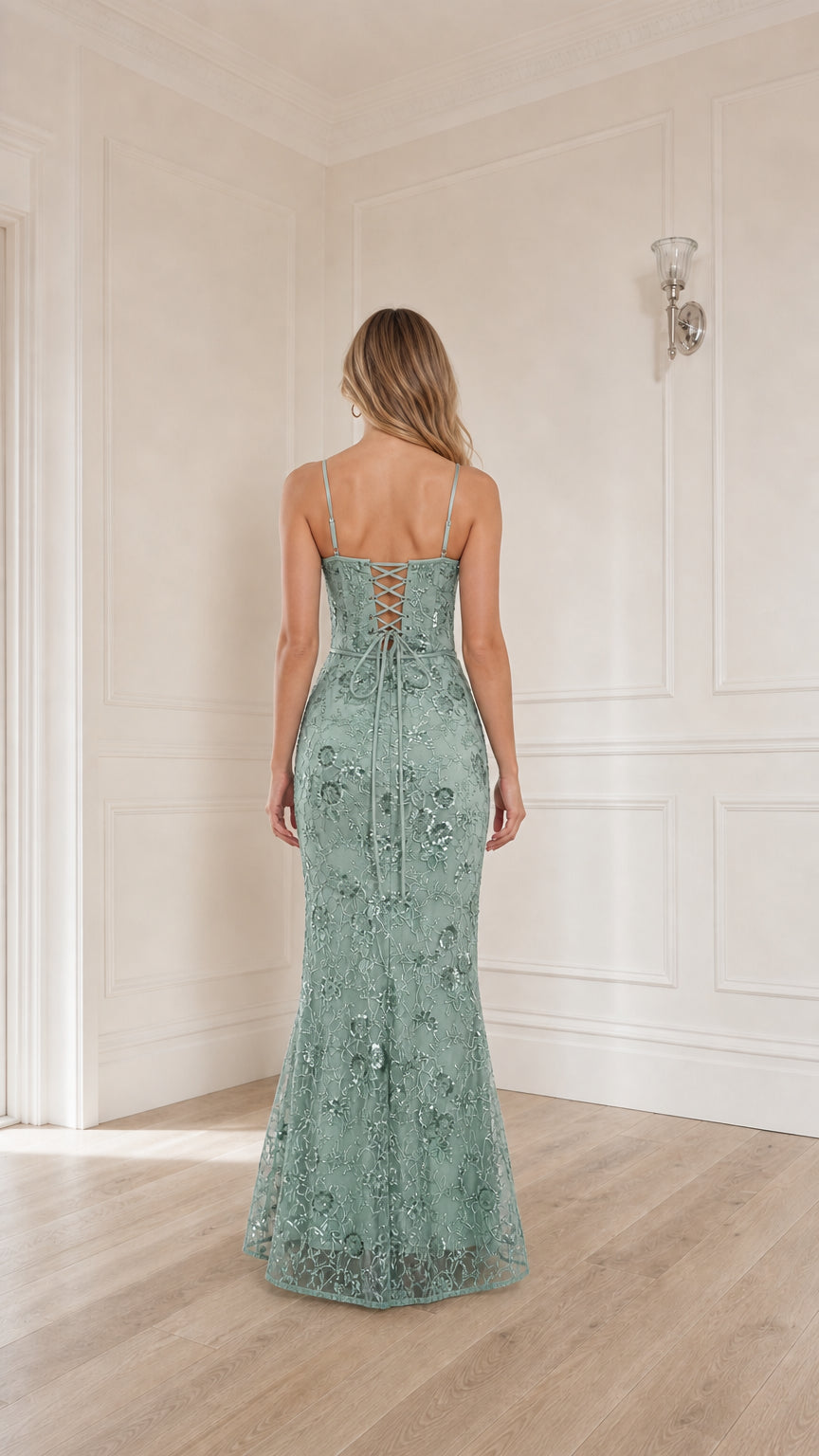 Woman wearing sage green sequin embroidered corset maxi dress, back view showing lace-up detail