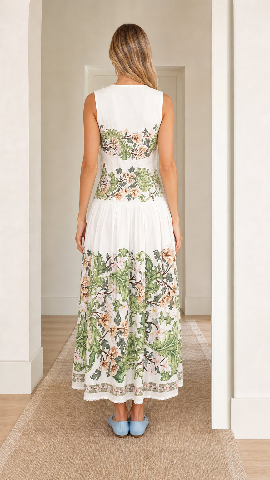 Back view of woman wearing white floral print cutout maxi dress