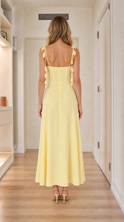 Back view of yellow corset maxi dress showing bow details