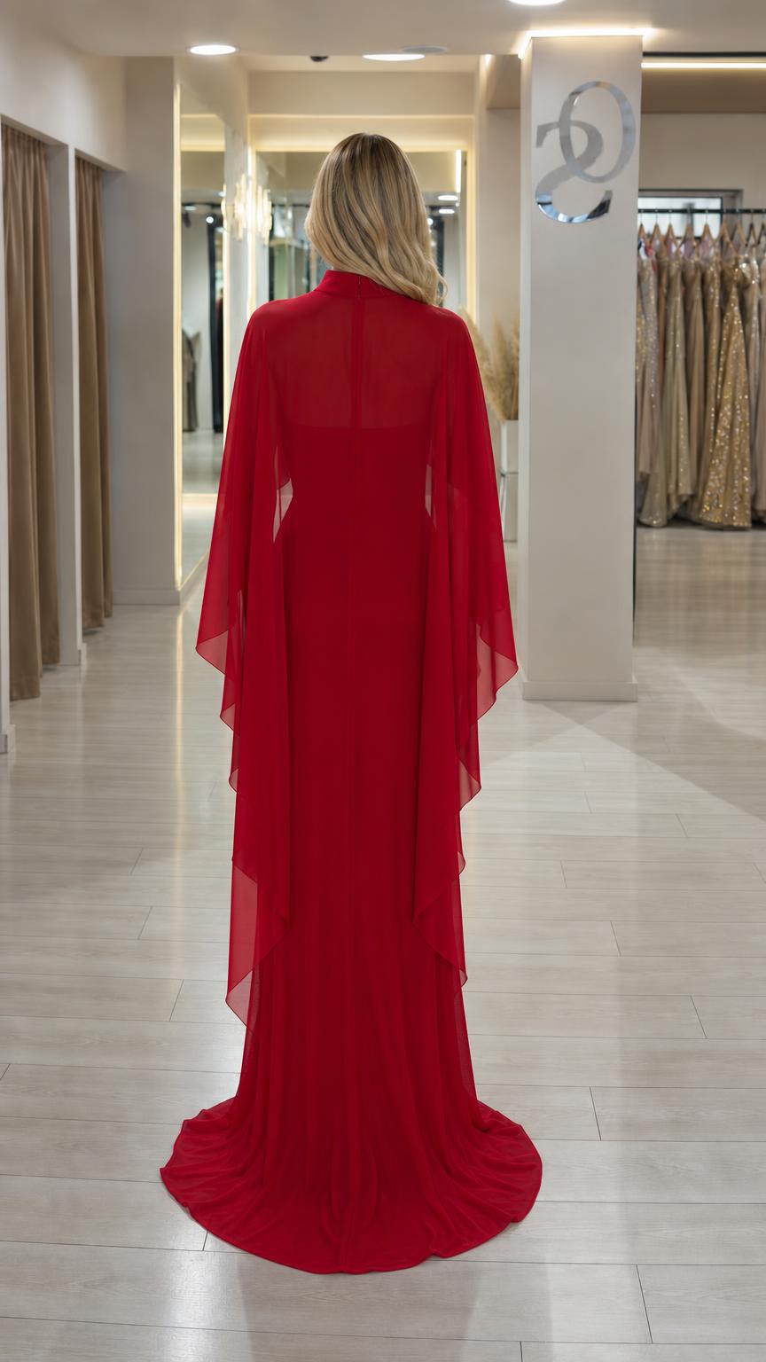 Back view of red evening dress with flowing cape