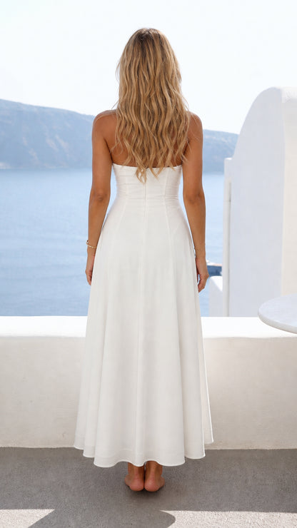 Back view of model showing open back design of white halter dress