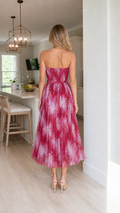 Back view of woman in fuchsia pleated midi dress