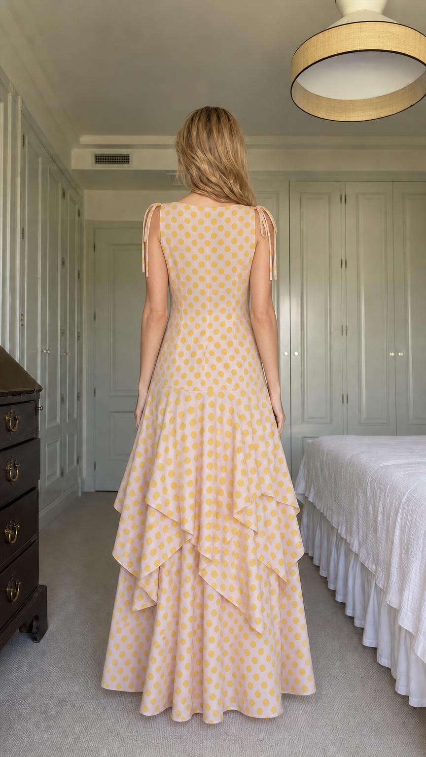 Back view of model in yellow polka dot tiered maxi dress