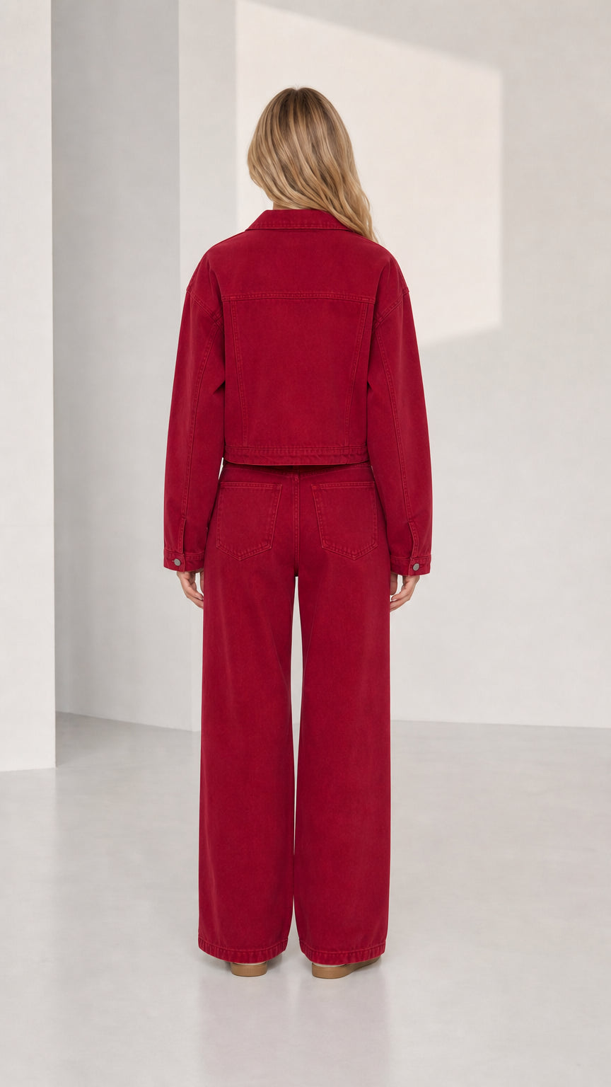 Woman wearing red denim set, back view