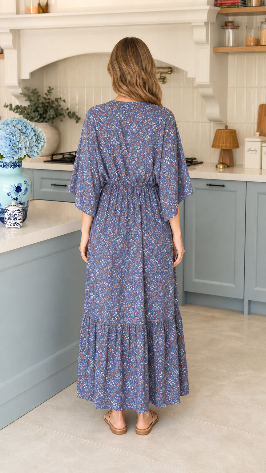 Back view of model wearing blue floral elastic waist maxi dress