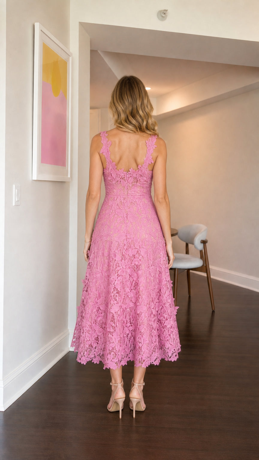 Model wearing pink floral lace midi dress from the back