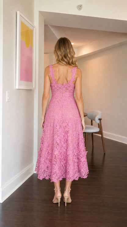 Model wearing pink floral lace midi dress from the back