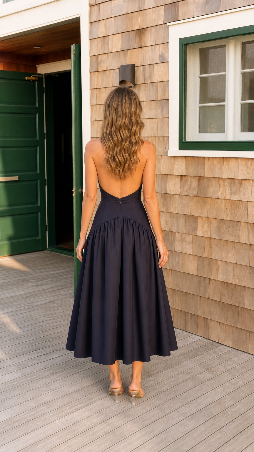 Back view of navy blue open back drop waist pleated midi dress