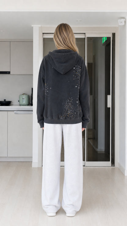Back view of woman showing scattered rhinestone detail on washed black hoodie