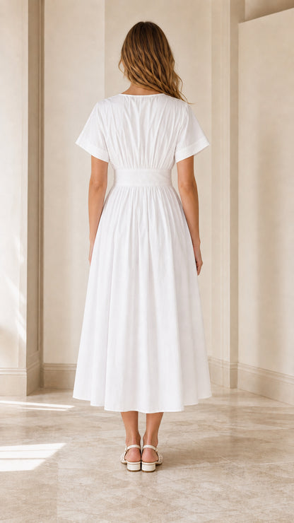 Back view of white pleated A-line midi dress