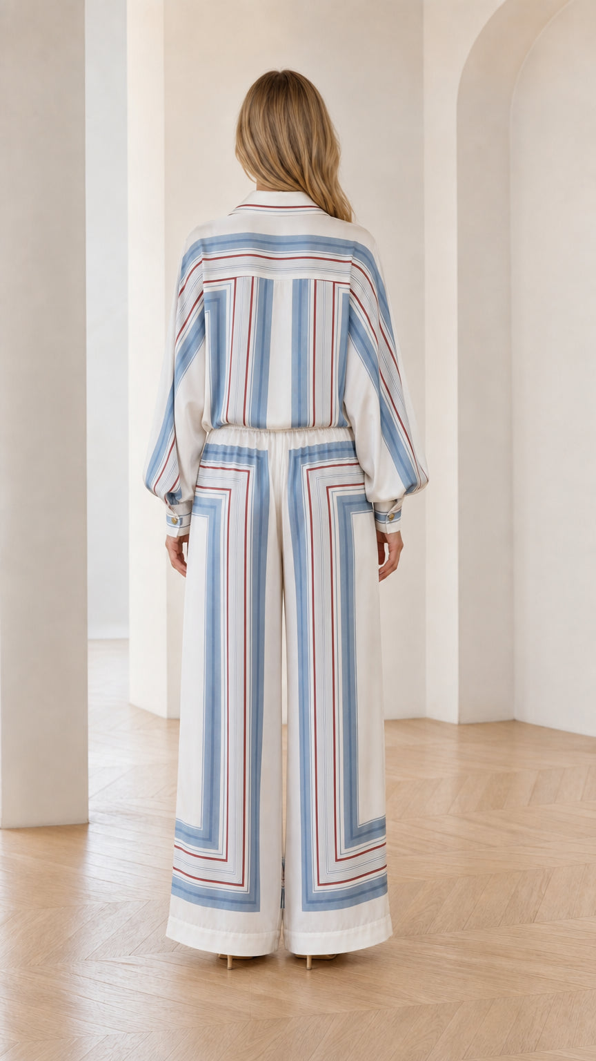Back view of model wearing white geometric striped matching set